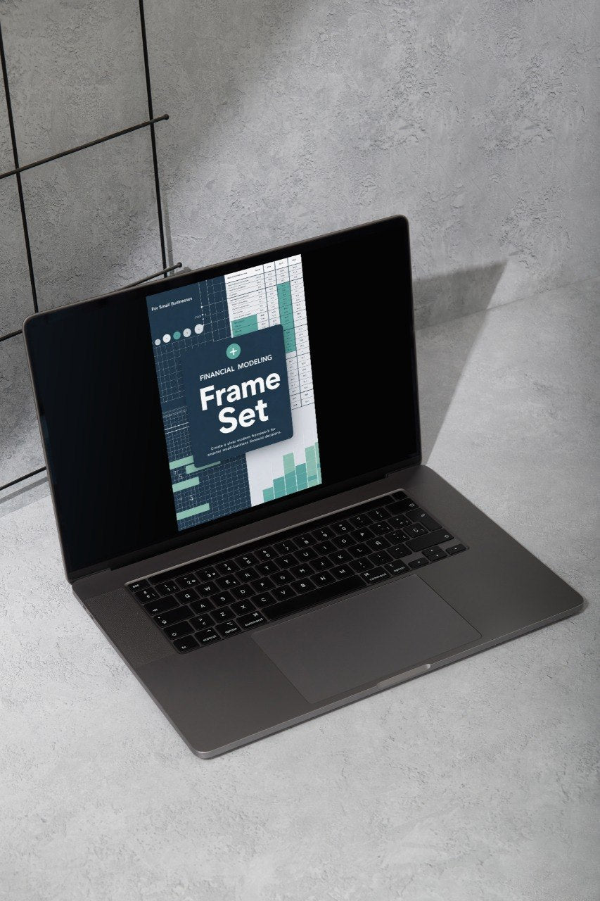 Laptop on a concrete floor with a screen displaying a 'Frame Set' design software interface.