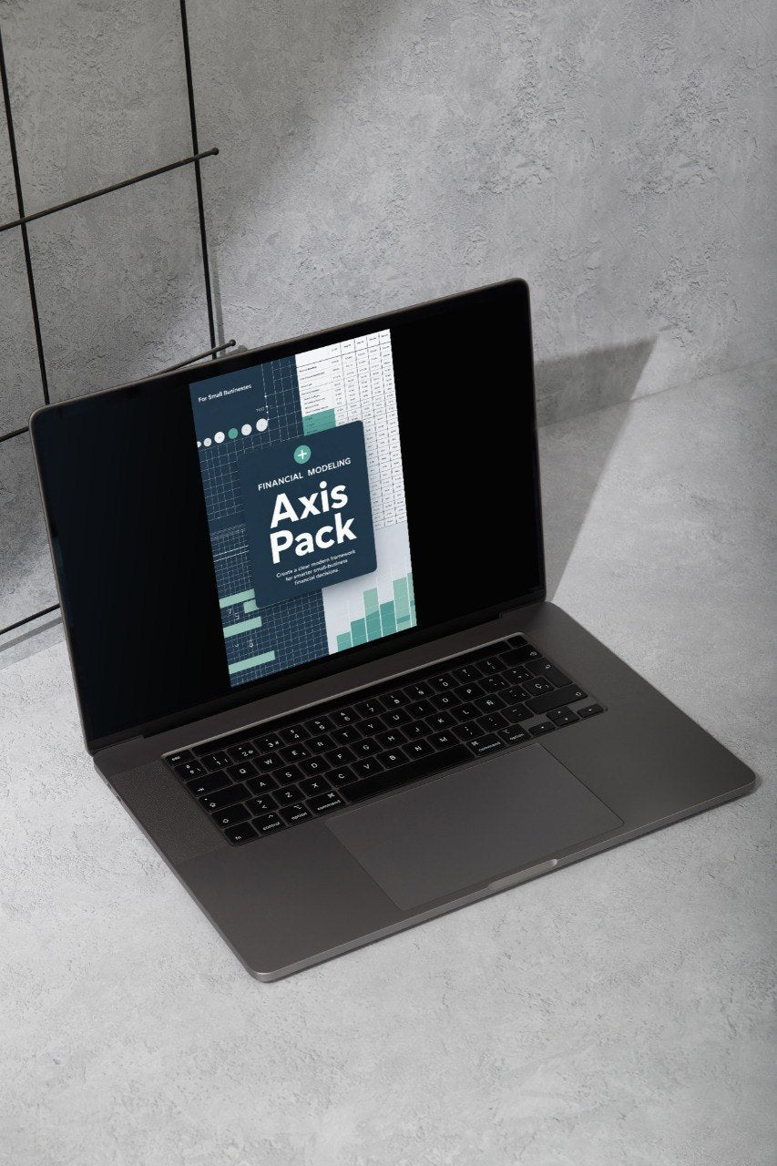 Laptop on a concrete floor with 'Axis Pack' software displayed on the screen