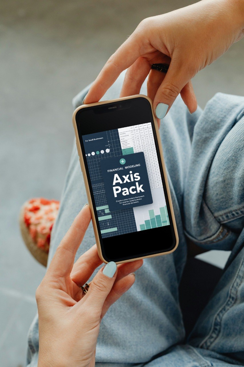 Person holding a smartphone displaying an app interface with 'Axis Pack' on the screen.